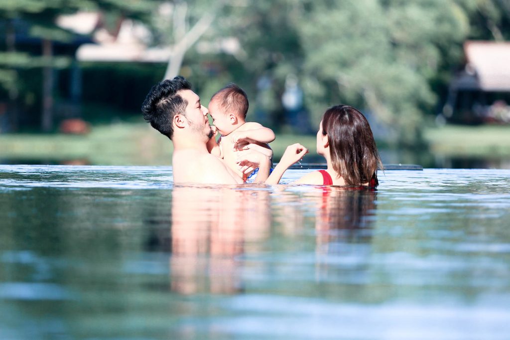 Family happy in swimming pool private villa